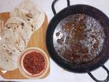 A picture of Wok spinach pork, naan and tomato pickle🍅🧄🧅🥬🌶️.