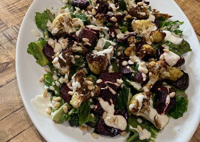 A picture of Spring greens, air fried cauliflower and beetroot salad with tahini dressing.