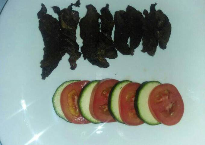 A picture of Grilled fillet strips with tomato and cucumber.