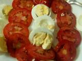 A picture of Tomato salad with boiled eggs.