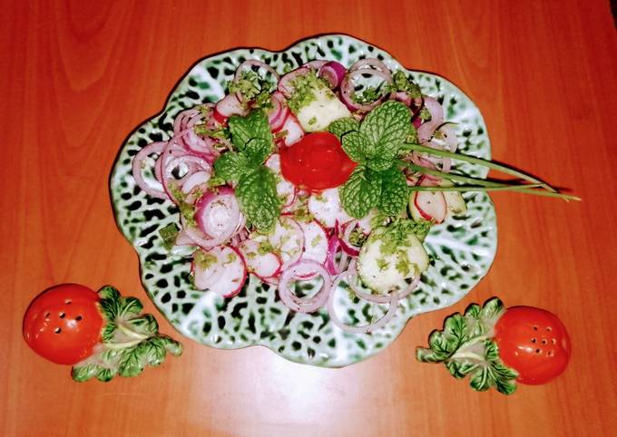 A picture of Red radish, onion, cucumber 🥗 salad.