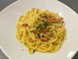 A picture of Tagliatelle with chanterelle mushrooms and guanciale.