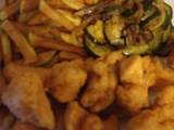 A picture of Fried Cajun chicken with homemade fries and courgette.