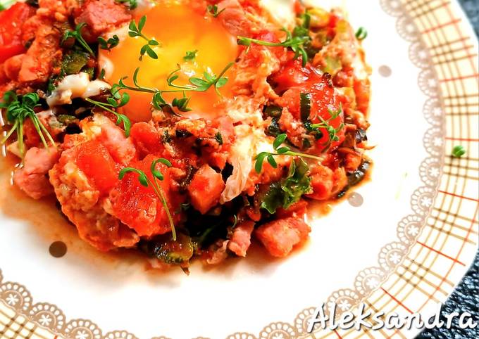 A picture of Fried Eggs with Bacon, Kale and Tomatoes.