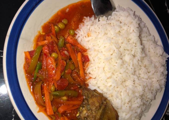 A picture of White rice and vegetable sauce.