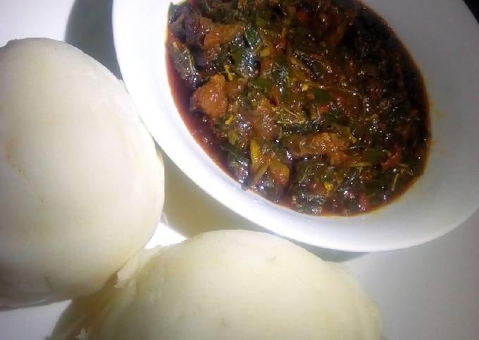 A picture of Pounded yam and vegetable soup.