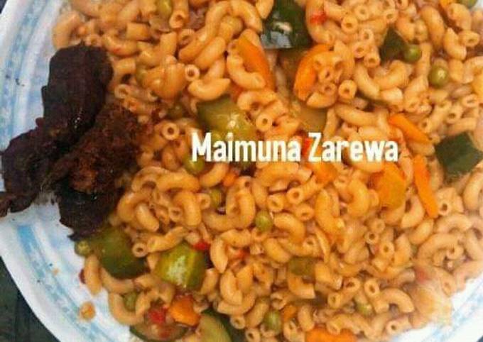 A picture of Macaroni vegetable jollof with grill beef.