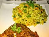 A picture of Vegetable couscous with tandoori chicken.