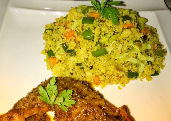 A picture of Vegetable couscous with tandoori chicken.