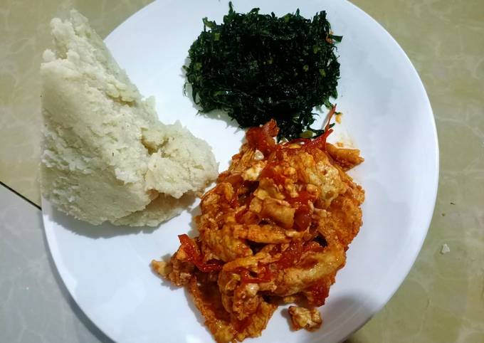 A picture of Ugali,fried sukuma (kales) and eggs.