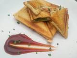 A picture of Sauteed vegetable sandwich toasted sesame seeds and tomato sauce.