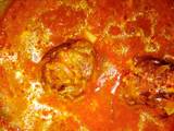 A picture of Meatballs in tomato sauce.