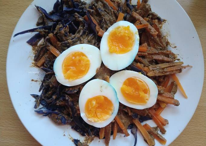 A picture of Vegetables salad with nuts sauce.