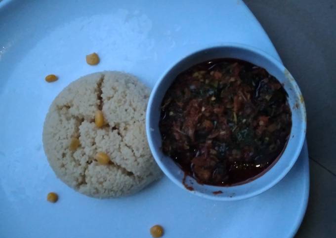 A picture of Cous cous with vegetable soup.