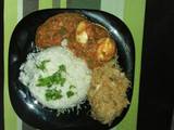 A picture of Rice,Egg Curry and cabbage.