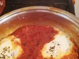 A picture of Shakshouka (eggs in tomato and basil sauce).