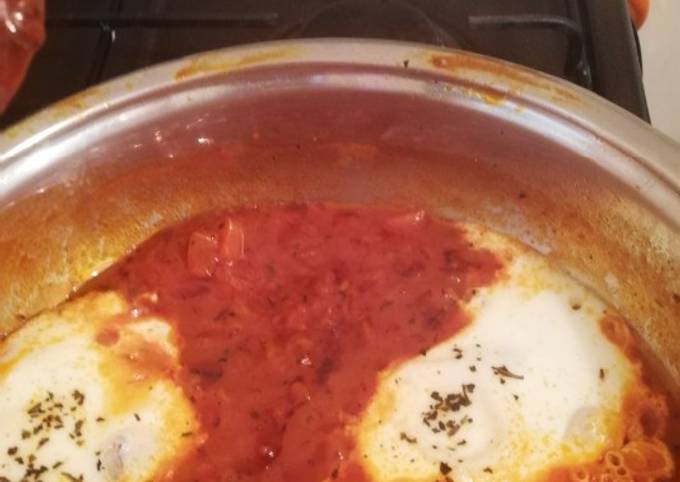 A picture of Shakshouka (eggs in tomato and basil sauce).