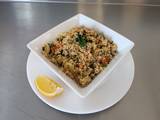 A picture of Couscous Salad with roasted vegetables and mixed herbs.