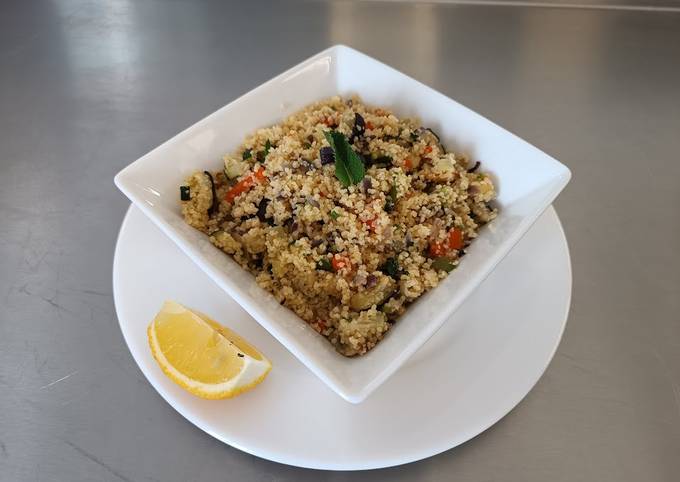 A picture of Couscous Salad with roasted vegetables and mixed herbs.