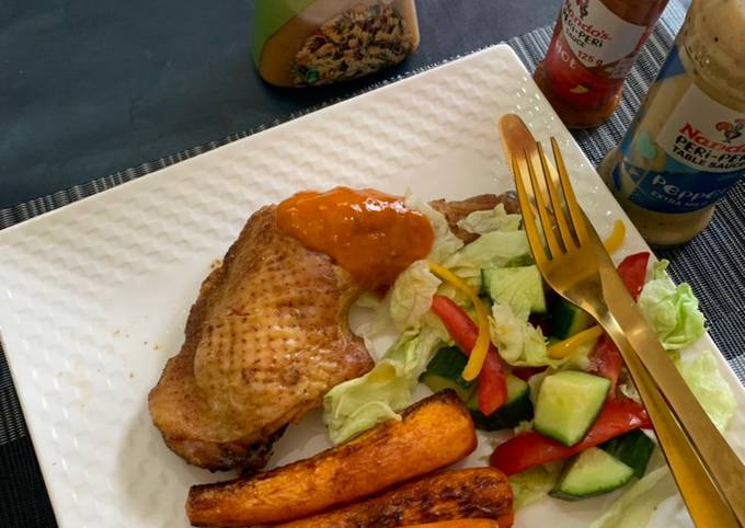 A picture of Roasted chicken,baked carrots and green salad.