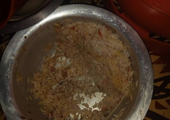 A picture of Mixture of rice and tomatoes.