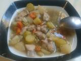 A picture of Vegetables and chicken soup.