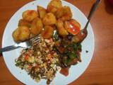 A picture of Roasted potatoes served with fried eggs & veges.