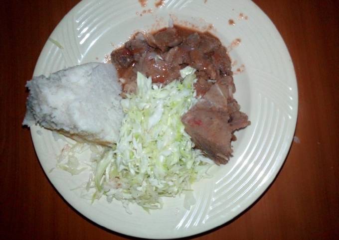 A picture of Beef ugali n steamed cabbage.