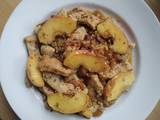 A picture of Pork with apple and onion.