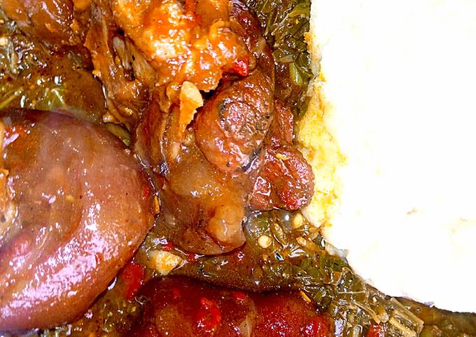 A picture of Pounded yam with groundnuts and vegetables soup.