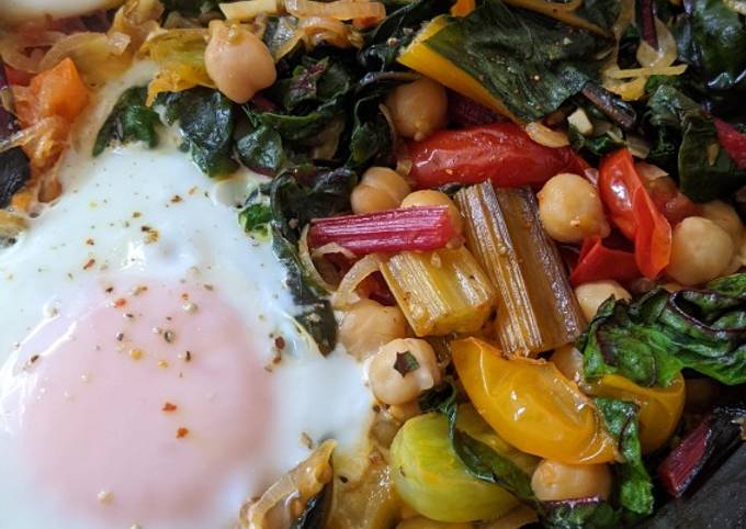 A picture of One-pan egg, tomato, chard + cumin brunch.