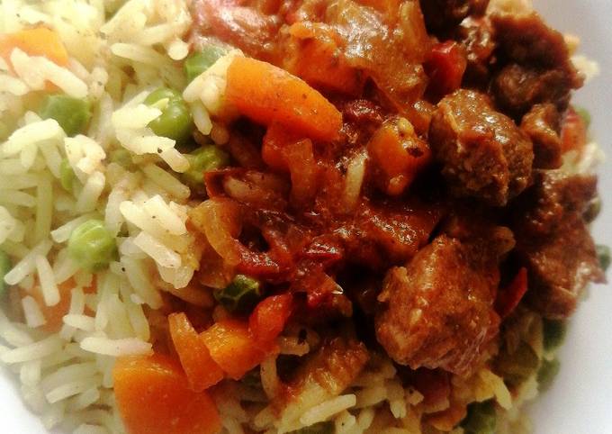 A picture of Wet fry goat meat with vegetable rice.