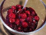 A picture of Red cherries/ mixed berries sauce/ dessert.