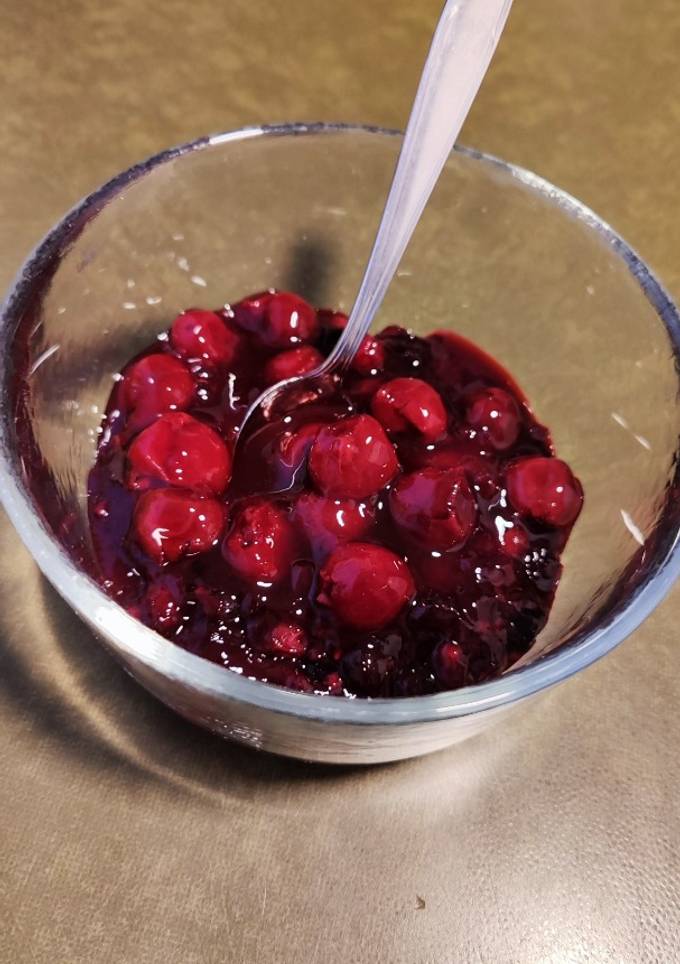 A picture of Red cherries/ mixed berries sauce/ dessert.