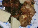 A picture of Cassava ugali with green vegetables and chicken.