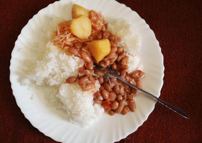 A picture of Rice with bean stew,cabbage and Irish potatoes.