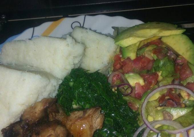 A picture of Goat roasted meat, greens and lettuce kachumbari.