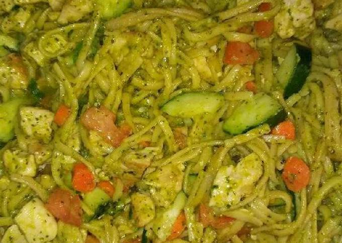 A picture of Chicken vegetables and pesto sauce pasta.