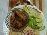 A picture of Kienyeji chicken with carrot rice and steamed cabbage.