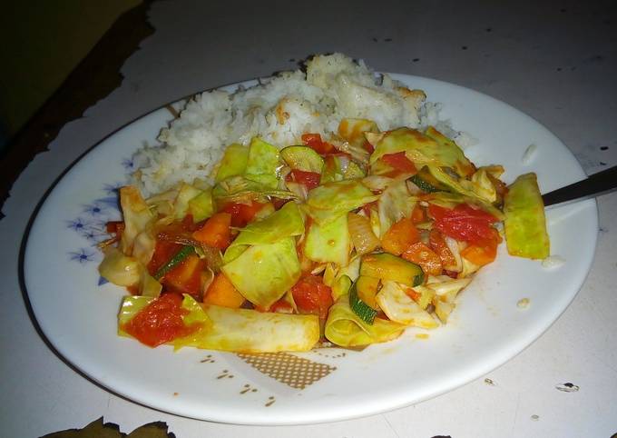 A picture of Rice with stir fry vegetables.