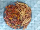 A picture of Potato chips and fried fish with peppered soup garnish with vegetables.