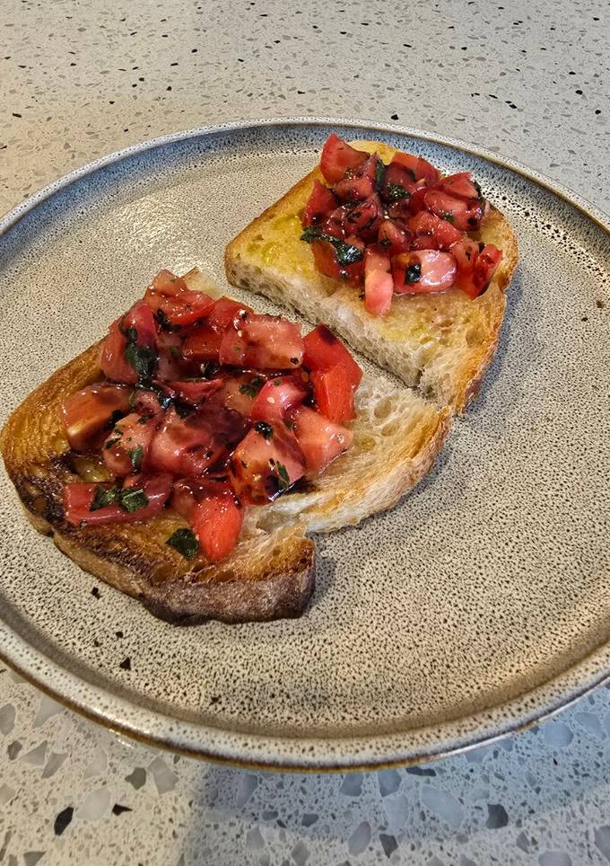 A picture of Marinated tomato on toast.