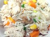 A picture of Rice with chicken and vegetables.