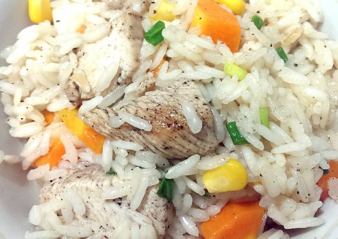 A picture of Rice with chicken and vegetables.