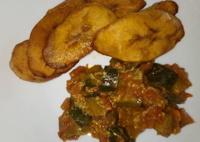 A picture of Breakfast leftover eggplants curry and plantain#Author marathon.