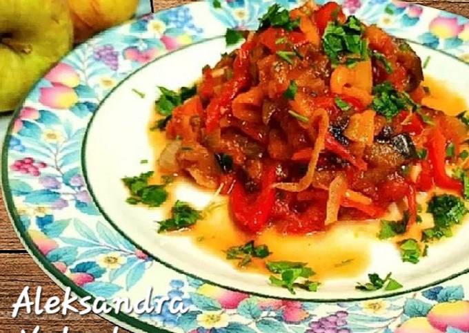 A picture of Eggplant with sweet peppers in tomato.