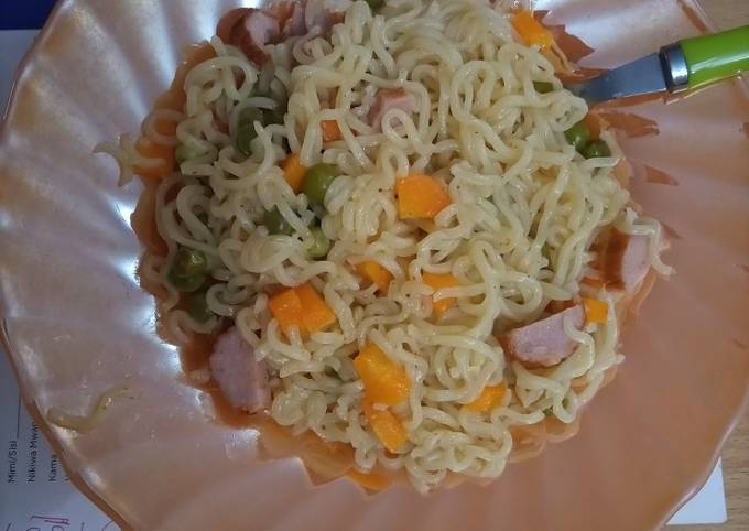 A picture of Veggie Indomie and sausage.