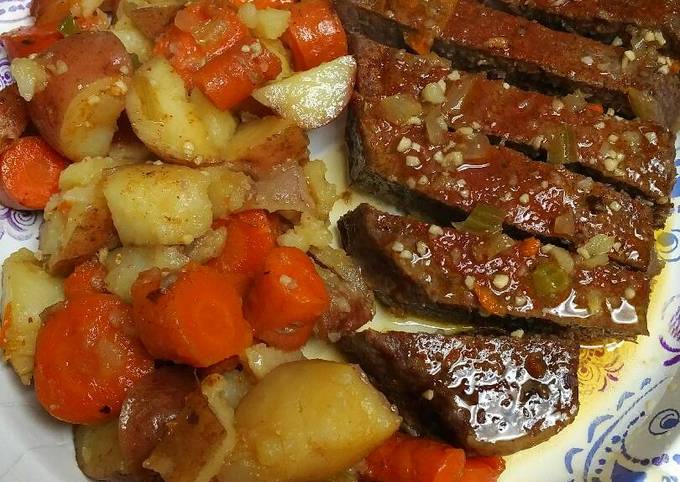 A picture of Roasted London Broil with vegetables.