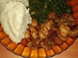 A picture of Ugali, fried pork and vegetable (sukuma wiki)# vegetables.