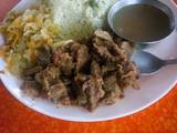 A picture of Vegetable rice with fried beef and steamed cabbage.